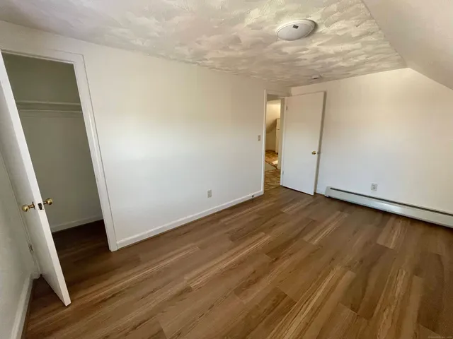 an empty room with wooden floor