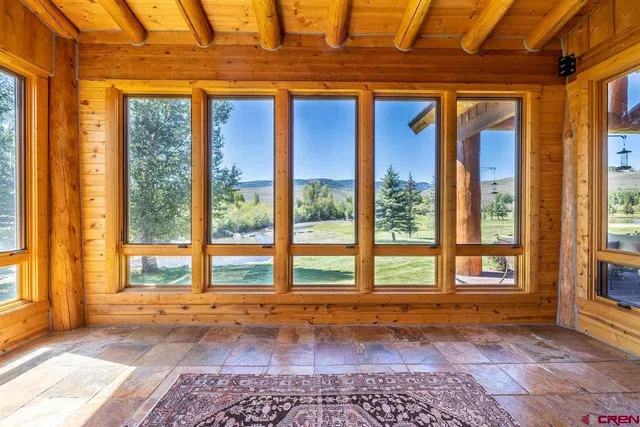 a view of a patio with table and chairs