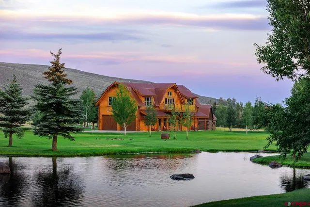 a view of a street with a house in the background