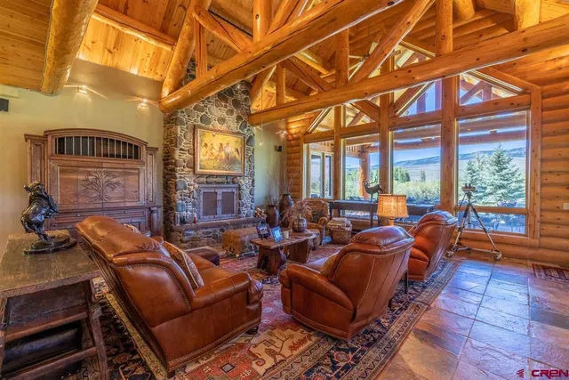 a view of a dining room with furniture large windows and wooden floor
