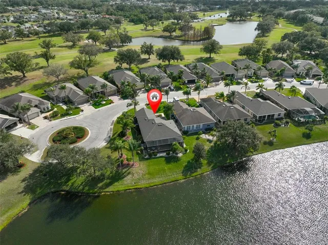 an aerial view of residential houses with outdoor space and swimming pool