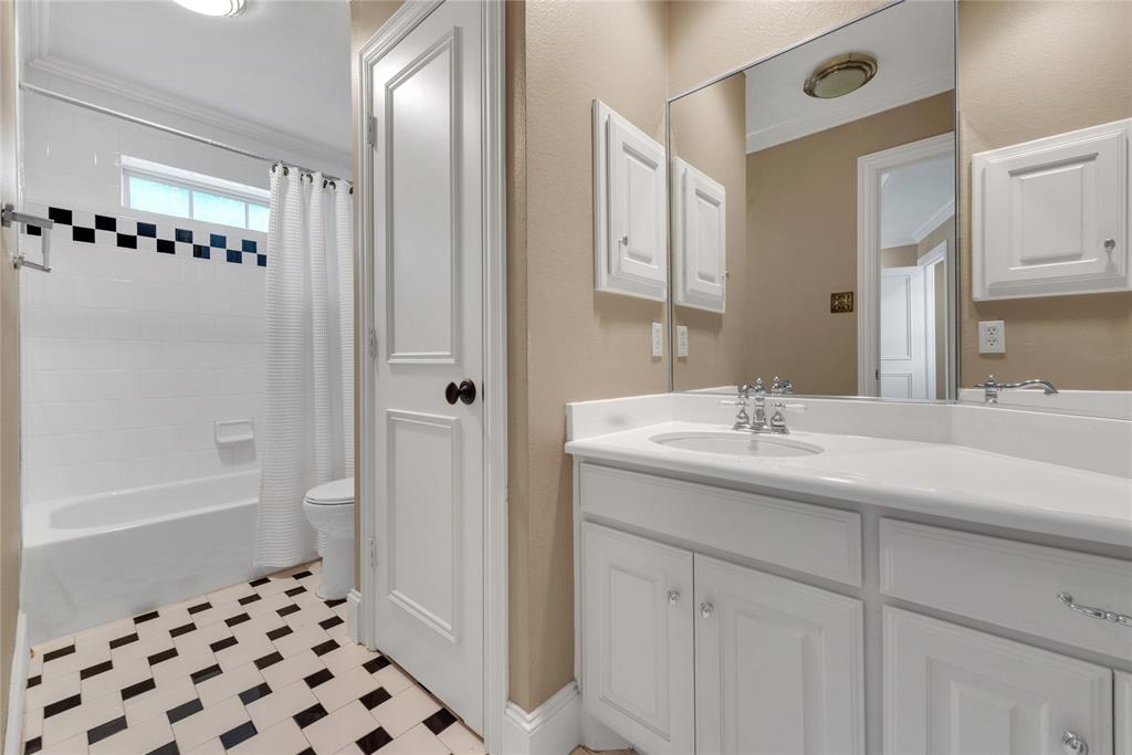 5102 Ridgedale Avenue Dallas, TX 75206 - Photo 20 of 27 Bathroom featuring a white vanity with an integrated sink, polished chrome faucet, and a large mirror