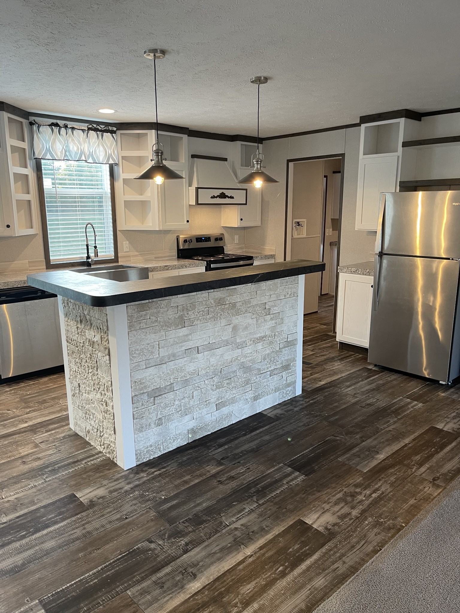 826 Pointe Lane Lafayette, TN 37083 - Photo 3 of 21 a kitchen with stainless steel appliances granite countertop a sink a refrigerator and a wooden floor