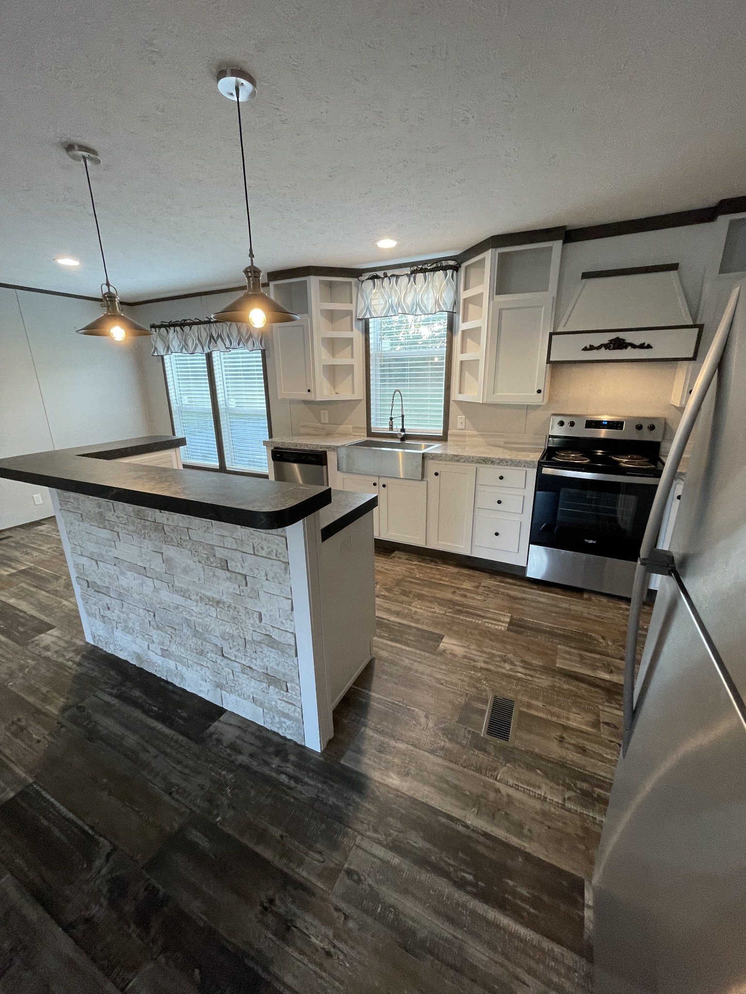 826 Pointe Lane Lafayette, TN 37083 - Photo 4 of 21 a kitchen with stainless steel appliances granite countertop a sink a stove and a wooden floors