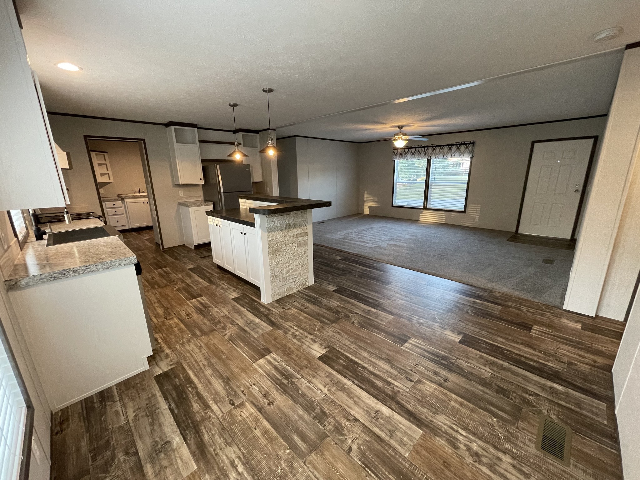 826 Pointe Lane Lafayette, TN 37083 - Photo 6 of 21 a large room with kitchen island a flat screen tv