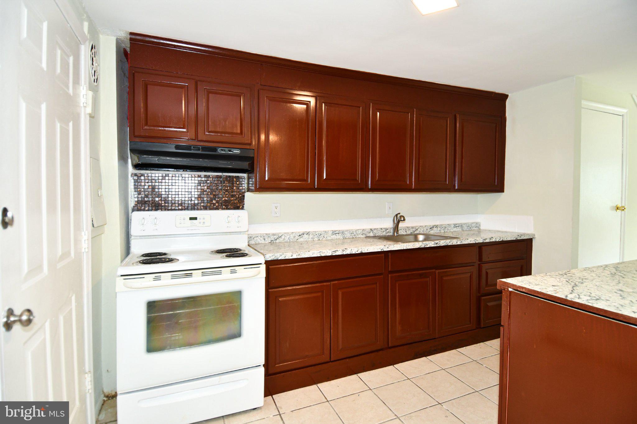 7768 Burnside Road Landover, MD 20785 - Photo 6 of 27 Modern kitchen with rich cabinetry.