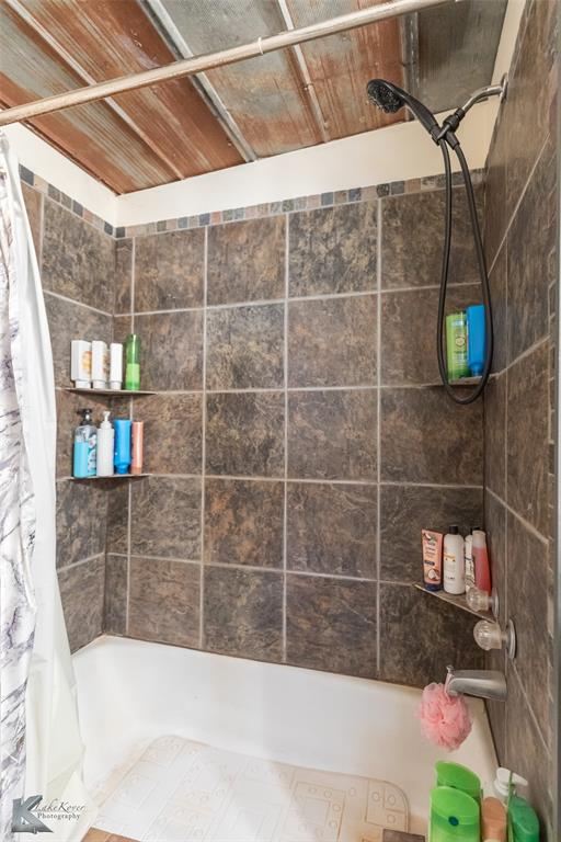 576 McCartney Lane Tye, TX 79563 - Photo 16 of 38 a bathroom with a bathtub and a shower