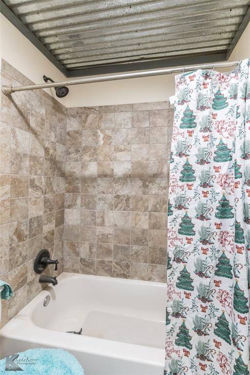 576 McCartney Lane Tye, TX 79563 - Photo 20 of 38 a bathroom with a bathtub and a shower curtain