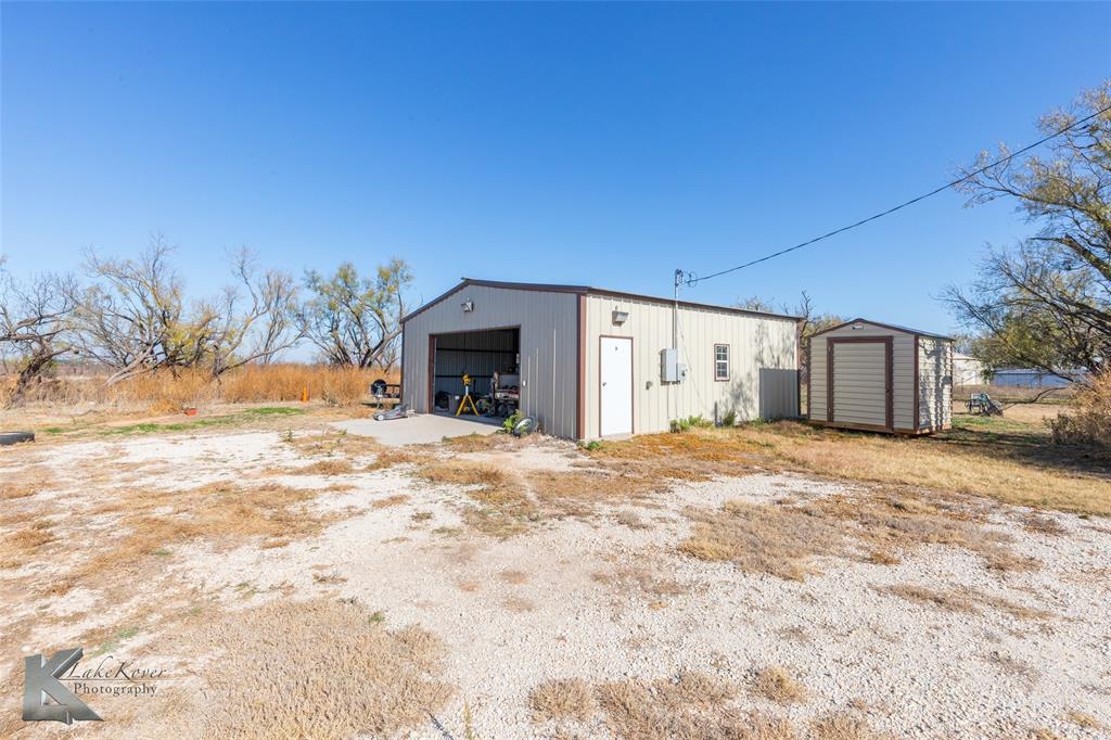 576 McCartney Lane Tye, TX 79563 - Photo 23 of 38 a view of a house with a yard and garage