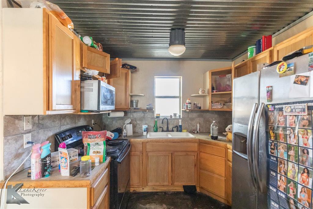 576 McCartney Lane Tye, TX 79563 - Photo 29 of 38 a utility room with cabinets dryer and washer
