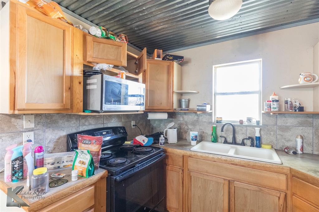 576 McCartney Lane Tye, TX 79563 - Photo 30 of 38 a kitchen with stainless steel appliances granite countertop a sink window and cabinets