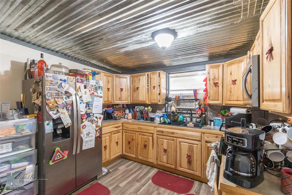 576 McCartney Lane Tye, TX 79563 - Photo 9 of 38 a kitchen that has a lot of appliances a sink and cabinets