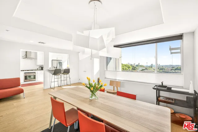 a kitchen with a table chairs stove and kitchen view