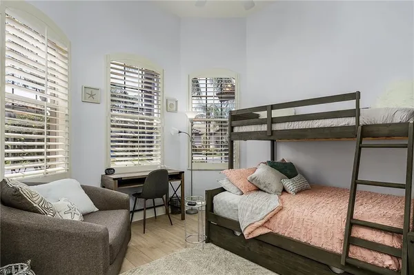 a bedroom with furniture and a window