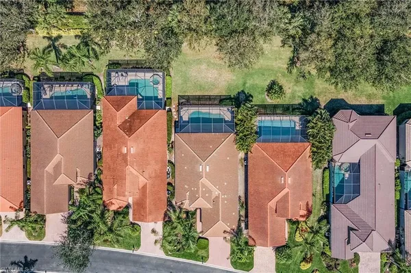 an aerial view of a house with a garden and trees