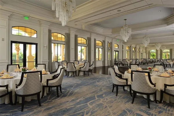 a view of a dining room with furniture and chandelier