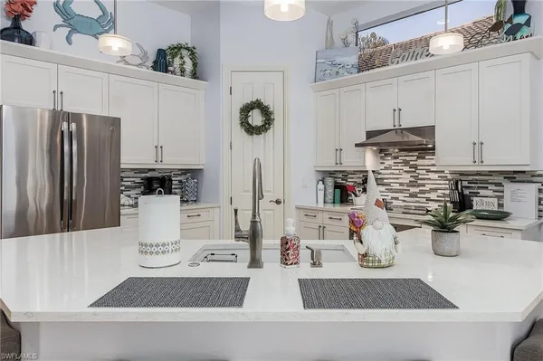 a kitchen with stainless steel appliances and white cabinets