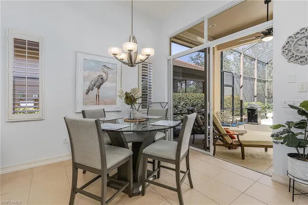 a view of a dining room with furniture wooden floor and chandelier