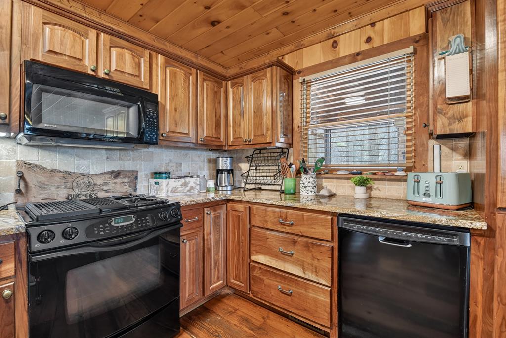 71 Rising Fawn Drive Mineral Bluff, GA 30559 - Photo 11 of 66 a kitchen with stainless steel appliances a stove a sink and a microwave