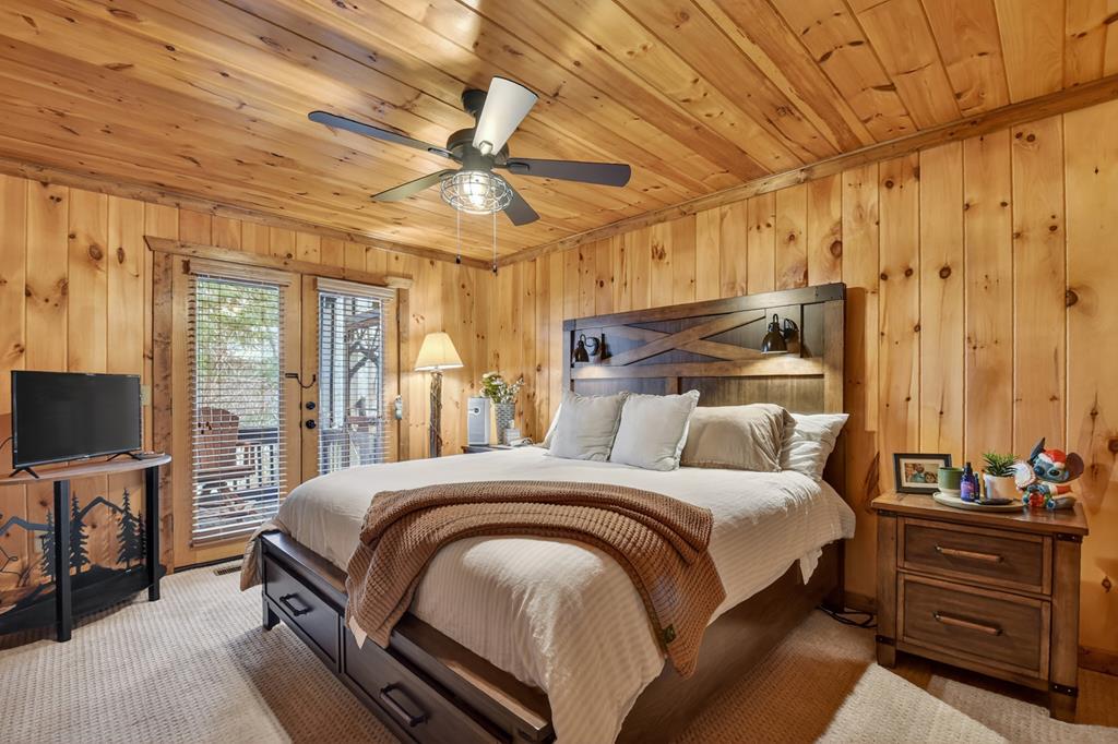 71 Rising Fawn Drive Mineral Bluff, GA 30559 - Photo 21 of 66 a bedroom with a bed and a flat tv screen on dresser