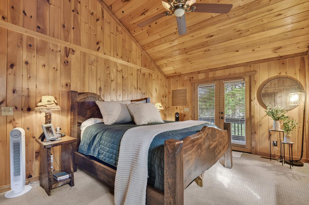 71 Rising Fawn Drive Mineral Bluff, GA 30559 - Photo 27 of 66 a bed room with a bed and a chandelier