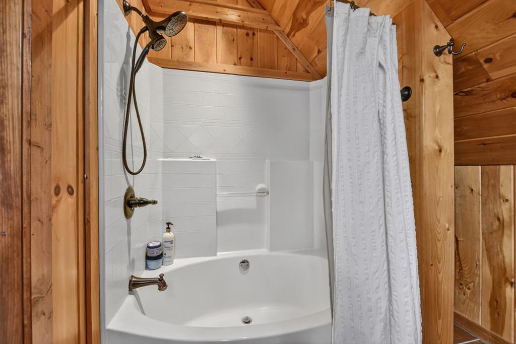 71 Rising Fawn Drive Mineral Bluff, GA 30559 - Photo 30 of 66 a bathroom with a bathtub and a shower