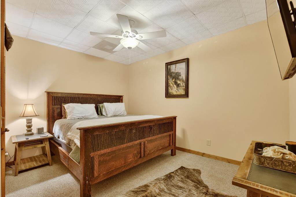 71 Rising Fawn Drive Mineral Bluff, GA 30559 - Photo 38 of 66 a bed room with a bed and a chandelier