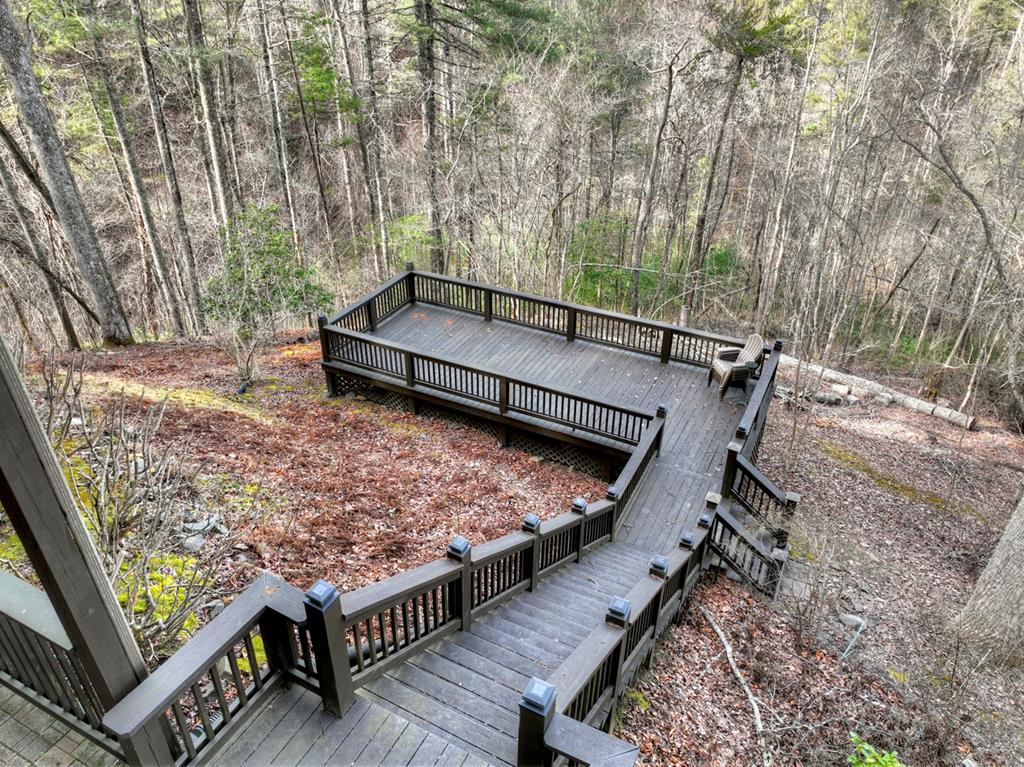 71 Rising Fawn Drive Mineral Bluff, GA 30559 - Photo 65 of 66 a view of a roof deck with wooden fence and a couple of chairs