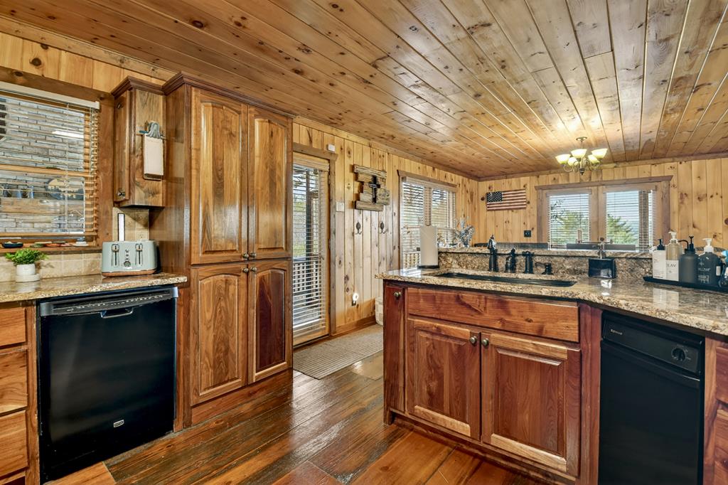 71 Rising Fawn Drive Mineral Bluff, GA 30559 - Photo 10 of 66 a kitchen with stainless steel appliances granite countertop a refrigerator a sink dishwasher a stove and white countertops with wooden floor