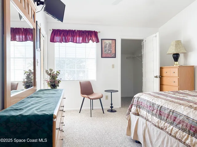 a bedroom with a bed and a table in it