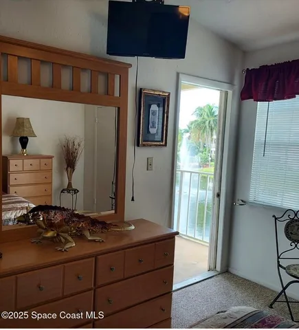 a room with a large bed and a large window