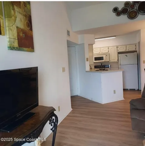 a kitchen with stainless steel appliances a stove microwave and refrigerator