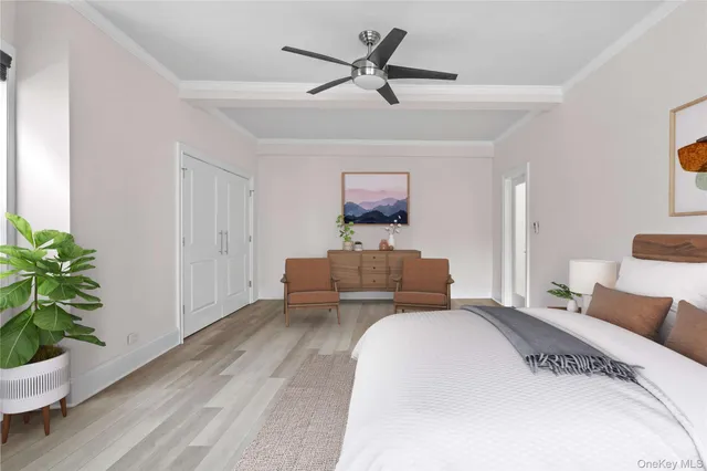 a bedroom with a bed and a potted plant