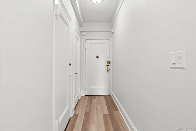 a view of a hallway with wooden floor