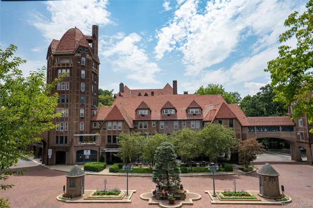 a view of backyard with table and chairs and a large tree