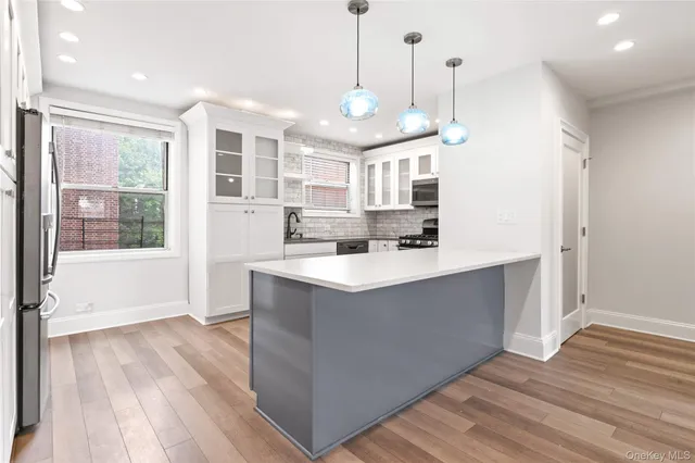 a view living room with wooden floor and windows