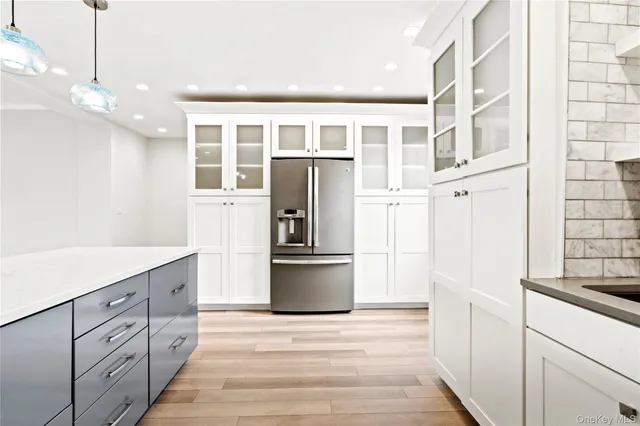 a kitchen with stainless steel appliances a refrigerator and a stove