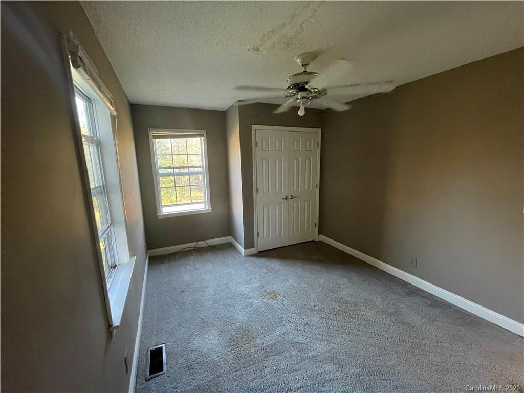 139 Bentley Town Road Union, SC 29379 - Photo 7 of 17 an empty room with windows and chandelier fan