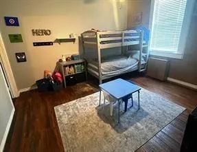 a living room with furniture a flat screen tv and a table