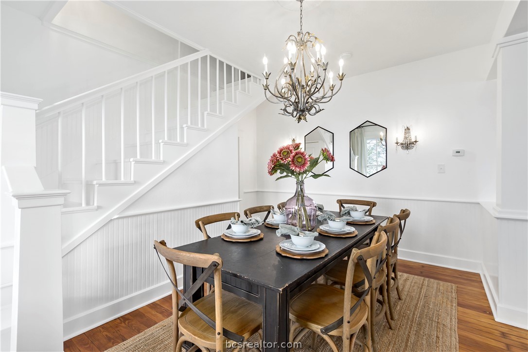 705 South Bryan Avenue Bryan, TX 77803 - Photo 13 of 47 a view of a dining room with furniture a chandelier and wooden floor