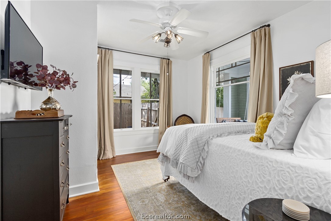 705 South Bryan Avenue Bryan, TX 77803 - Photo 16 of 47 a bedroom with a bed and a chandelier