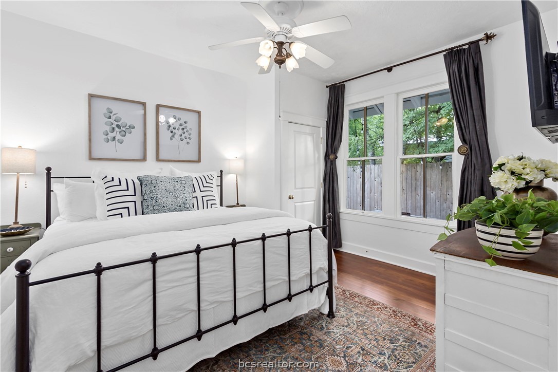 705 South Bryan Avenue Bryan, TX 77803 - Photo 18 of 47 a bedroom with a bed and a potted plant