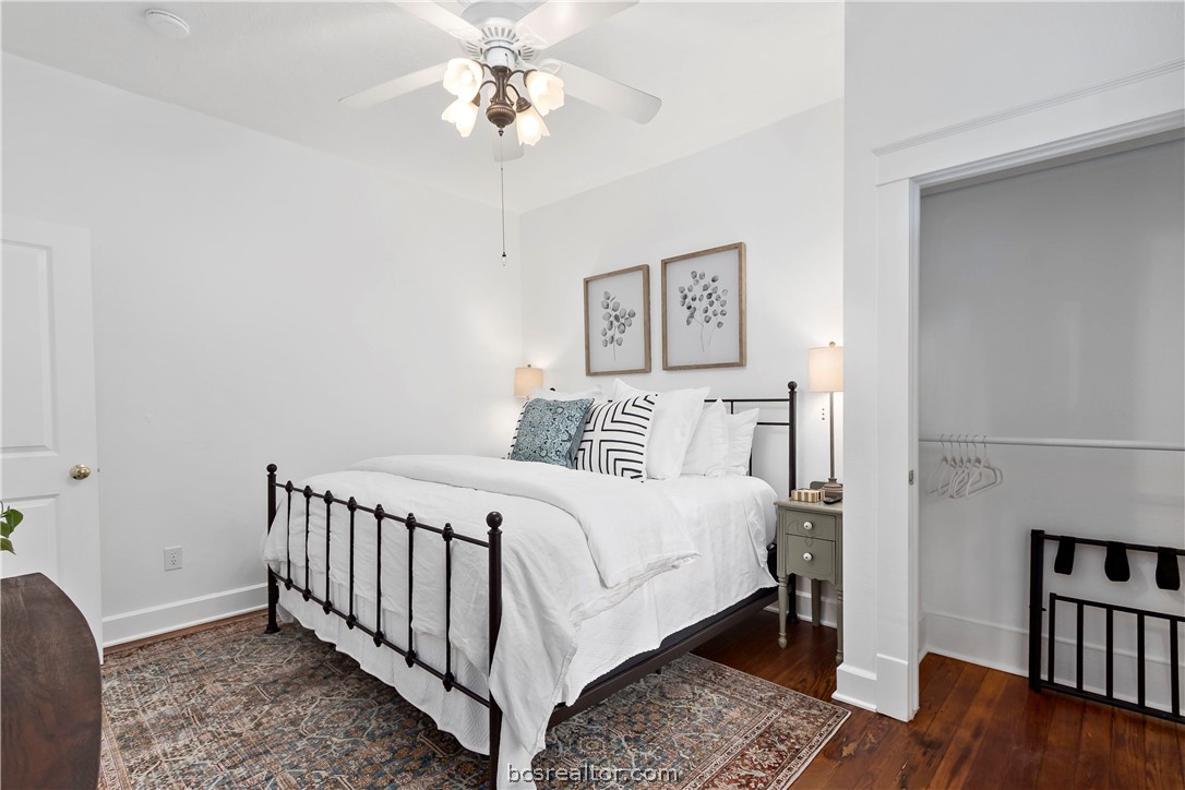705 South Bryan Avenue Bryan, TX 77803 - Photo 19 of 47 a bedroom with a bed and wooden floor