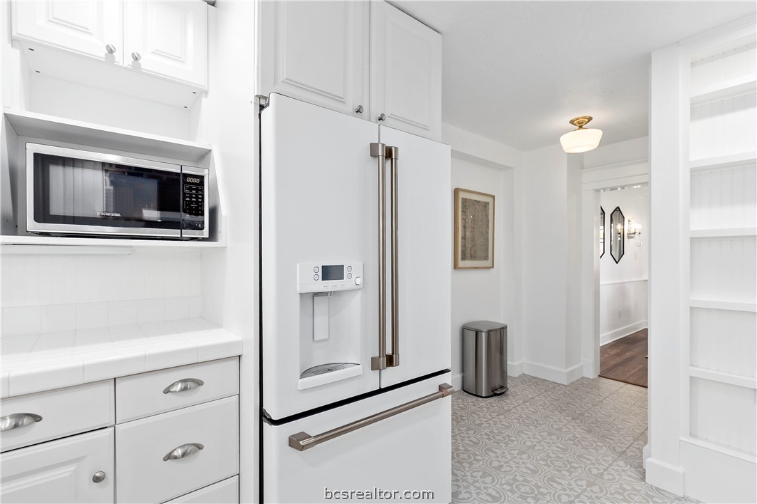 705 South Bryan Avenue Bryan, TX 77803 - Photo 26 of 47 a kitchen with stainless steel appliances a refrigerator and a stove top oven