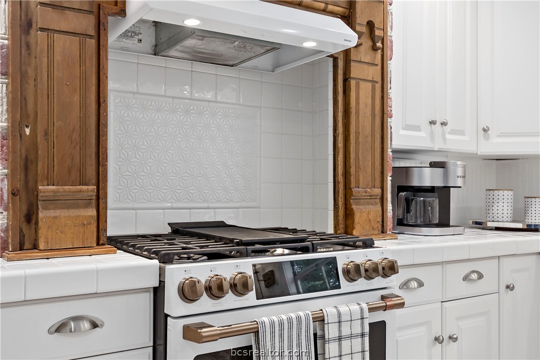 705 South Bryan Avenue Bryan, TX 77803 - Photo 27 of 47 a white stove top oven sitting inside of a kitchen