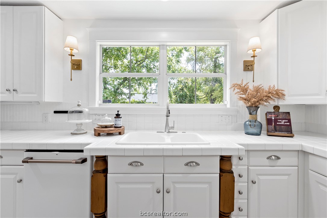 705 South Bryan Avenue Bryan, TX 77803 - Photo 28 of 47 a kitchen with a sink cabinets and window