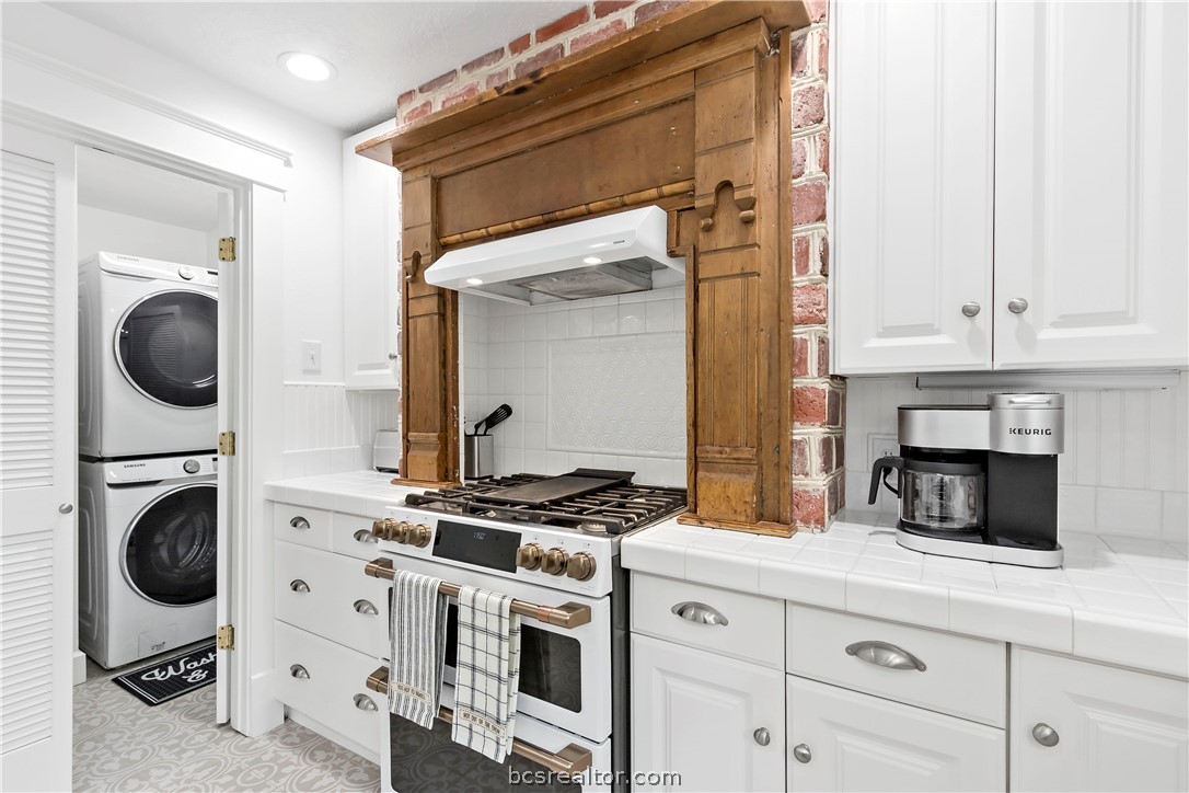 705 South Bryan Avenue Bryan, TX 77803 - Photo 29 of 47 a kitchen with white cabinets and a stove top oven