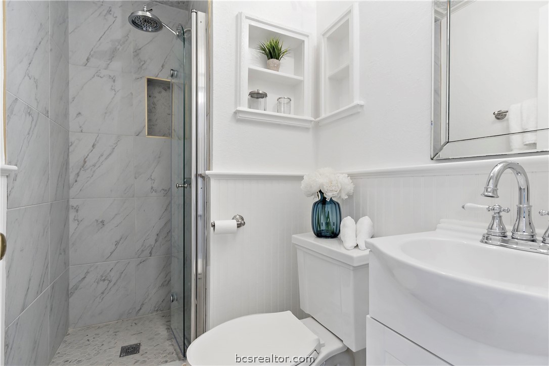 705 South Bryan Avenue Bryan, TX 77803 - Photo 32 of 47 a bathroom with a sink a toilet and shower