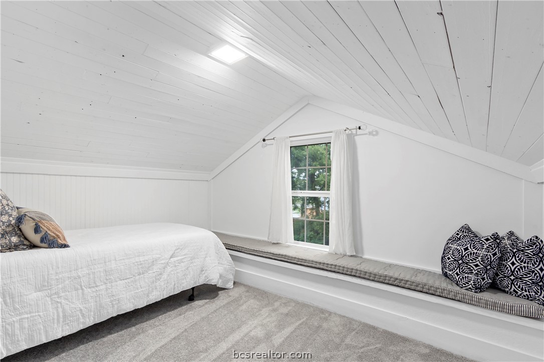 705 South Bryan Avenue Bryan, TX 77803 - Photo 37 of 47 a bedroom with a bed window and a mirror