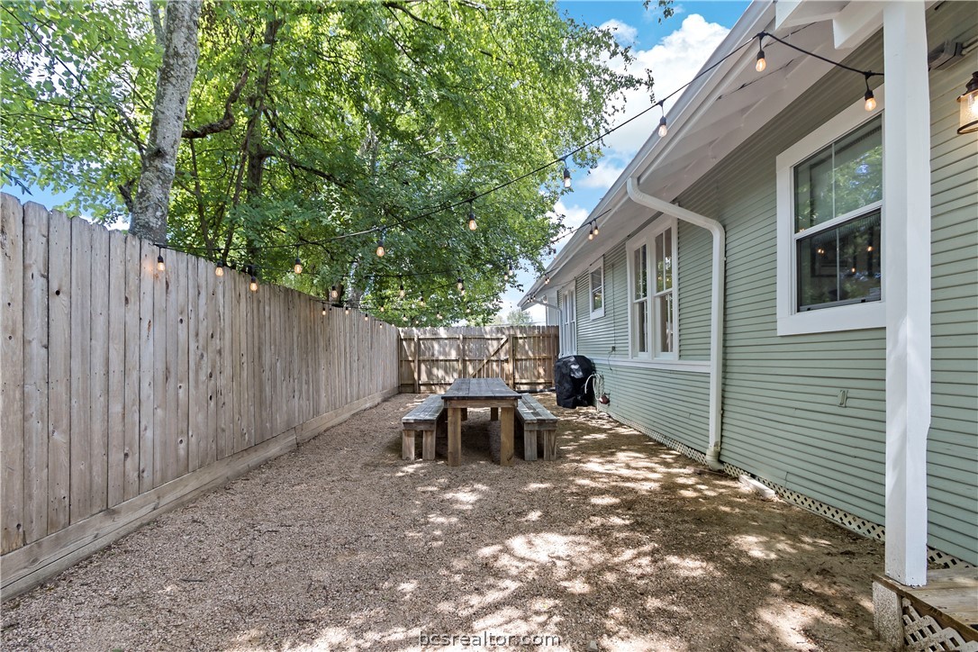 705 South Bryan Avenue Bryan, TX 77803 - Photo 39 of 47 a view of a patio with table and chairs and wooden fence